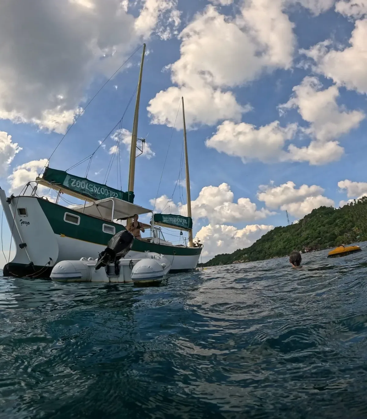 SV Freedom Fargo at a dive site under a dramatic Gulf of Thailand sky